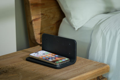 Phone under The Sleep Shield EMF-blocking cover beside bed
